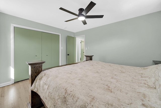 bedroom with light wood finished floors, a closet, and a ceiling fan