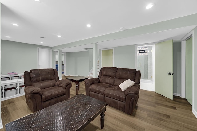 living room with stairway, wood finished floors, and recessed lighting