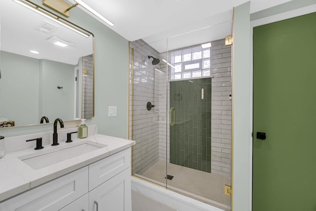 bathroom featuring a shower stall, visible vents, and vanity