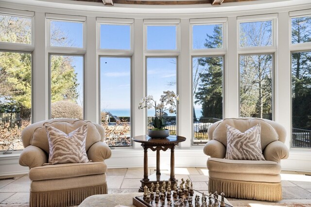 sunroom / solarium with a water view and visible vents