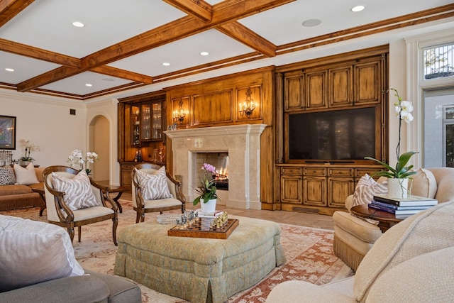 living area featuring arched walkways, recessed lighting, coffered ceiling, a fireplace, and beamed ceiling