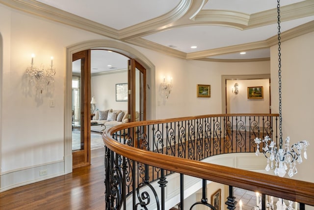 hall featuring arched walkways, recessed lighting, an upstairs landing, ornamental molding, and dark wood finished floors