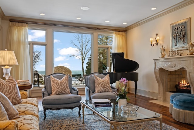 living room with baseboards, ornamental molding, wood finished floors, and a high end fireplace