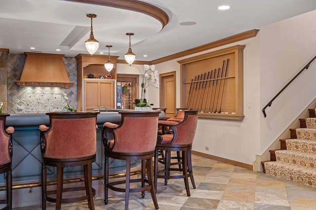 bar with decorative light fixtures, recessed lighting, a bar, baseboards, and stairs