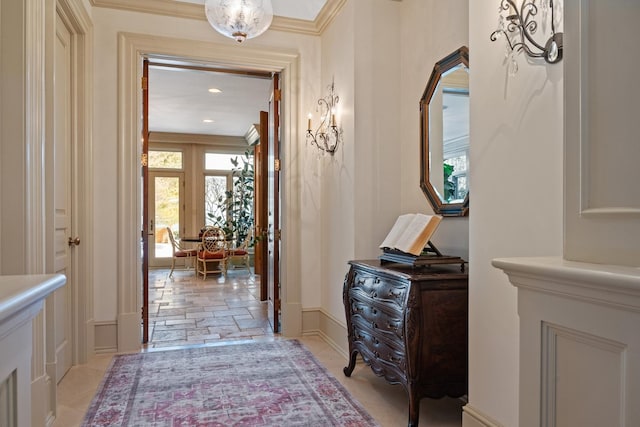 hall featuring stone finish flooring and baseboards