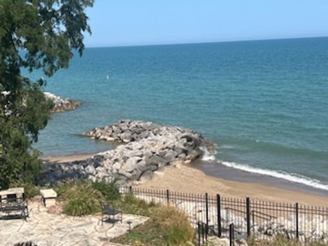 water view with fence and a beach view