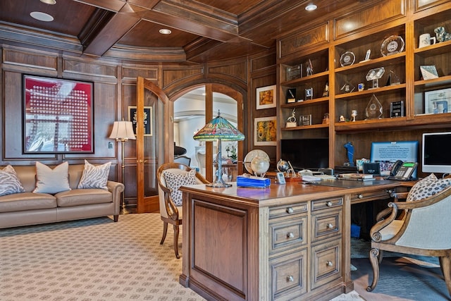 home office with coffered ceiling, wood ceiling, ornamental molding, wood walls, and built in desk