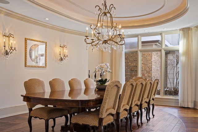 dining area with ornamental molding, a raised ceiling, and plenty of natural light