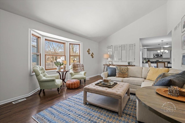 living room featuring high vaulted ceiling, a chandelier, and dark wood-type flooring