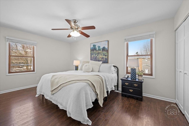 bedroom featuring dark hardwood / wood-style flooring, ceiling fan, and a closet