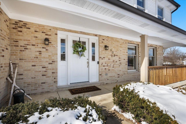 view of snow covered property entrance