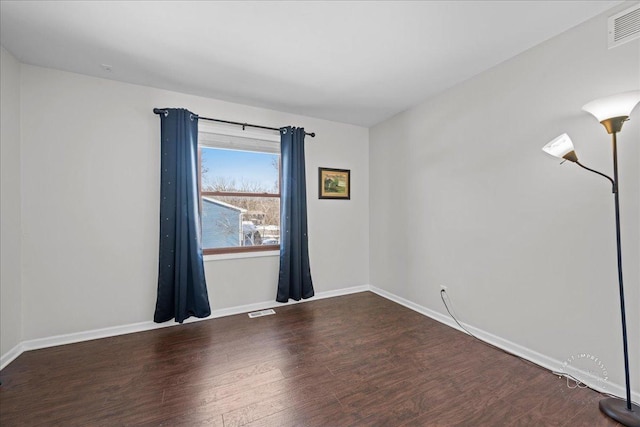 empty room with hardwood / wood-style flooring