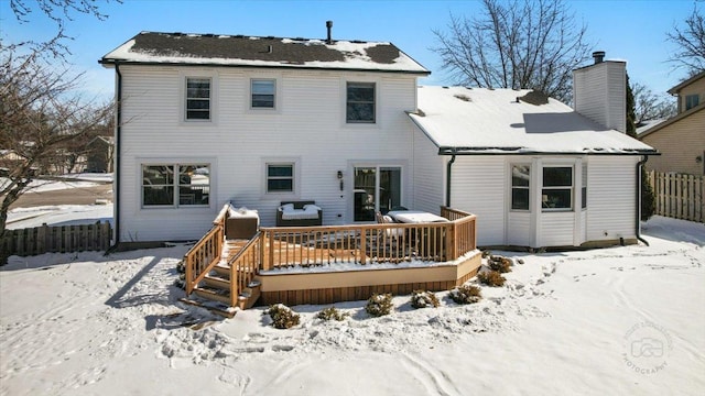 snow covered property with a deck