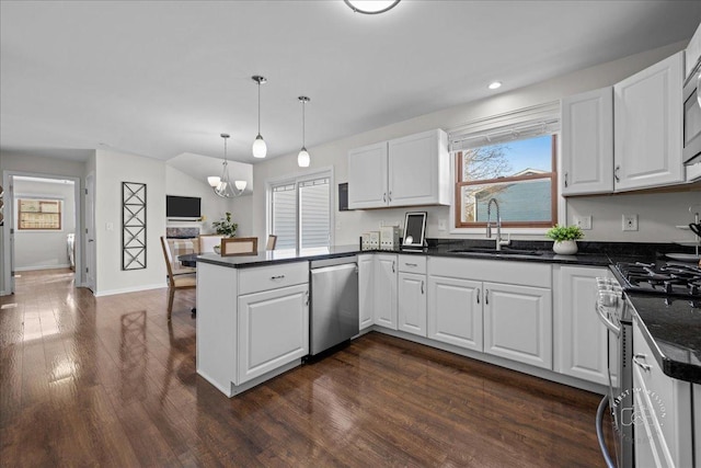 kitchen with white cabinets, appliances with stainless steel finishes, and sink