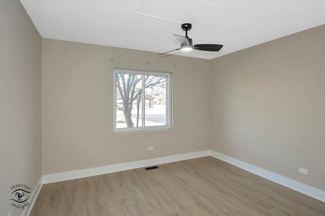 unfurnished room with light wood-type flooring, baseboards, visible vents, and ceiling fan