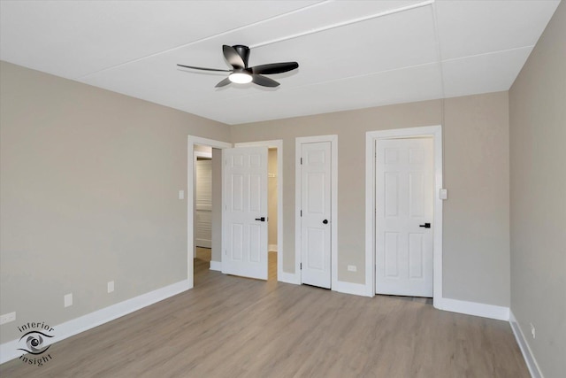 unfurnished bedroom featuring a ceiling fan, wood finished floors, and baseboards