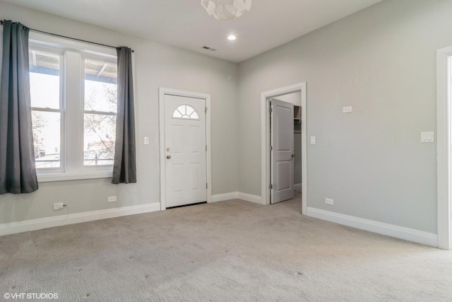 carpeted foyer with plenty of natural light