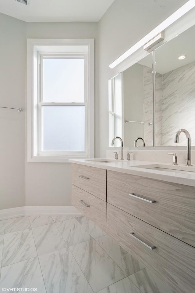 bathroom featuring a healthy amount of sunlight and vanity