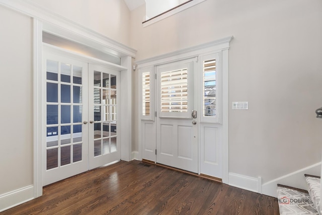 entryway featuring french doors, dark wood finished floors, and baseboards