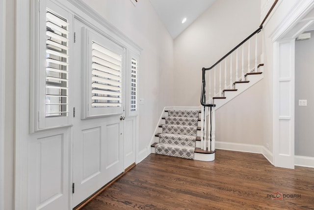 entryway featuring dark wood-style floors, recessed lighting, vaulted ceiling, baseboards, and stairs