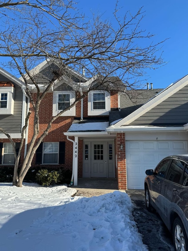 view of front of property featuring a garage and brick siding