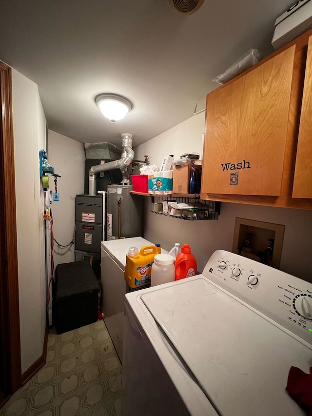 laundry area with cabinet space, water heater, visible vents, and separate washer and dryer