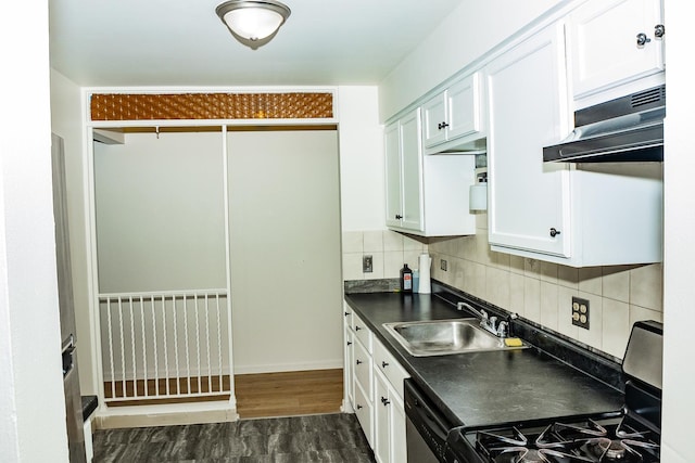 kitchen with sink, decorative backsplash, gas stove, and white cabinets