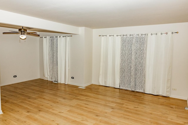 empty room featuring ceiling fan and light wood-type flooring