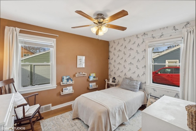 bedroom with ceiling fan and light wood-type flooring