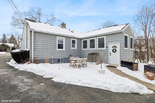 view of snow covered back of property