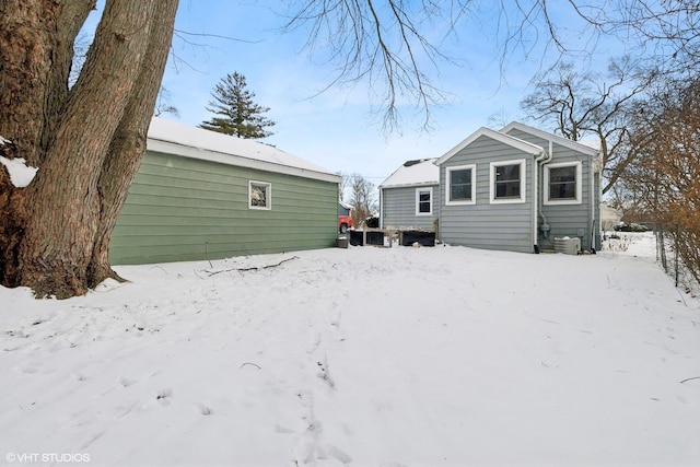 snow covered property with cooling unit