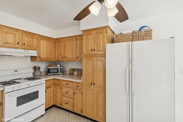 kitchen featuring ceiling fan and white appliances