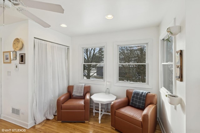 sitting room featuring ceiling fan and wood-type flooring