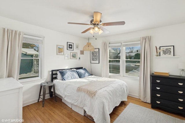 bedroom with ceiling fan and light hardwood / wood-style flooring