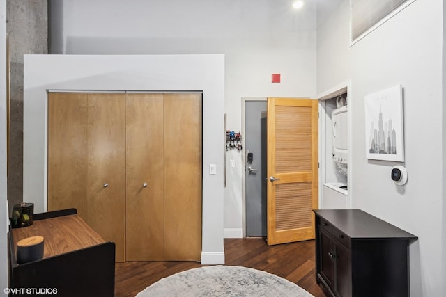 bedroom with dark wood-type flooring and a closet