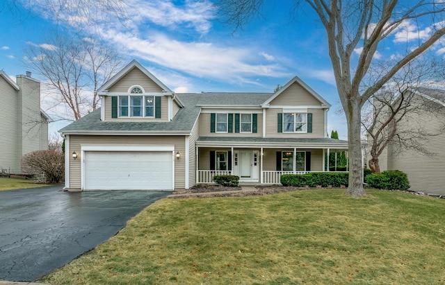 traditional home featuring driveway, roof with shingles, an attached garage, a porch, and a front yard