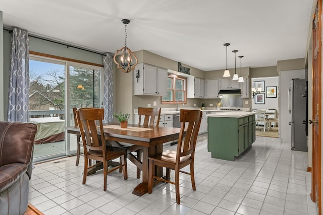 dining space with light tile patterned floors and visible vents