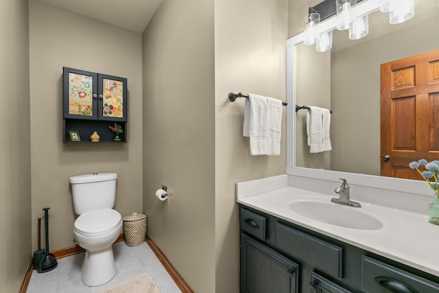 half bathroom with toilet, tile patterned floors, baseboards, and vanity