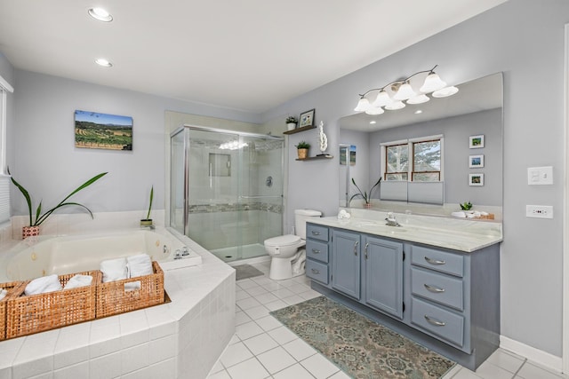 full bathroom with a jetted tub, a shower stall, vanity, and tile patterned floors