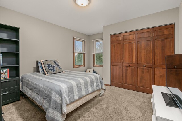 bedroom with a closet and carpet flooring