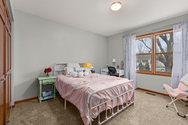 bedroom featuring baseboards, visible vents, and carpet flooring