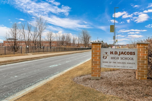 community sign featuring fence