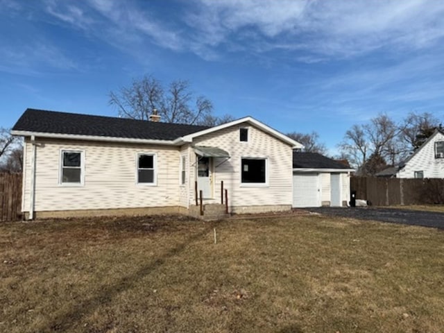 view of front of property with a garage and a front yard