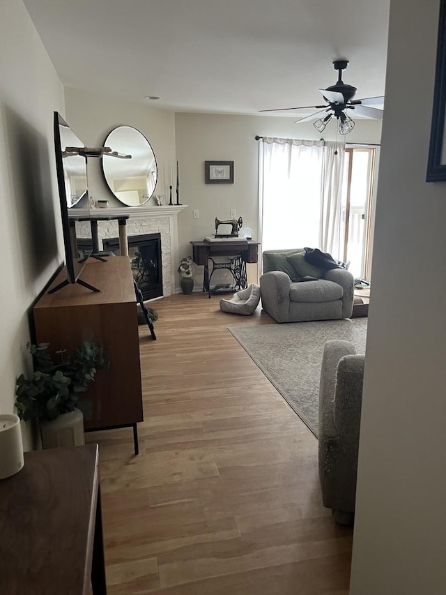 living room featuring ceiling fan and light wood-type flooring