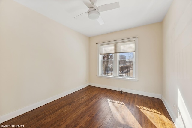 spare room with ceiling fan and dark hardwood / wood-style flooring