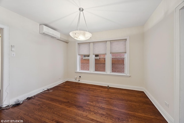 empty room featuring an AC wall unit and dark wood-type flooring