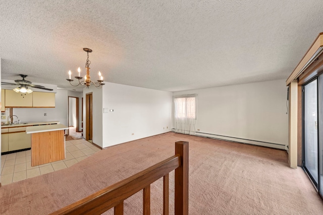 unfurnished living room featuring light tile patterned flooring, a sink, a textured ceiling, light carpet, and baseboard heating