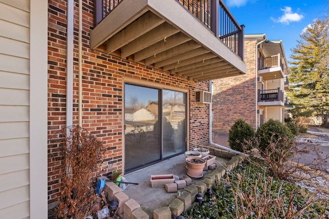 entrance to property featuring brick siding