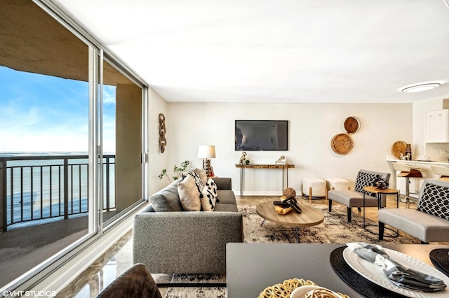 living room featuring expansive windows and a water view