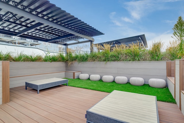 deck with fence and a pergola